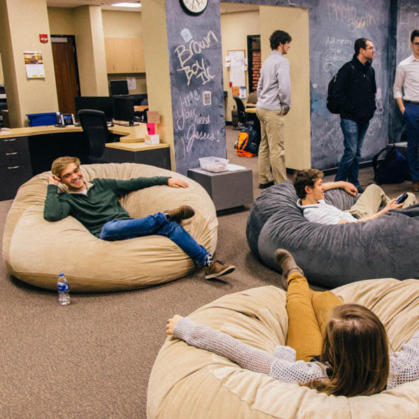 students relaxing and lying in lazy couch